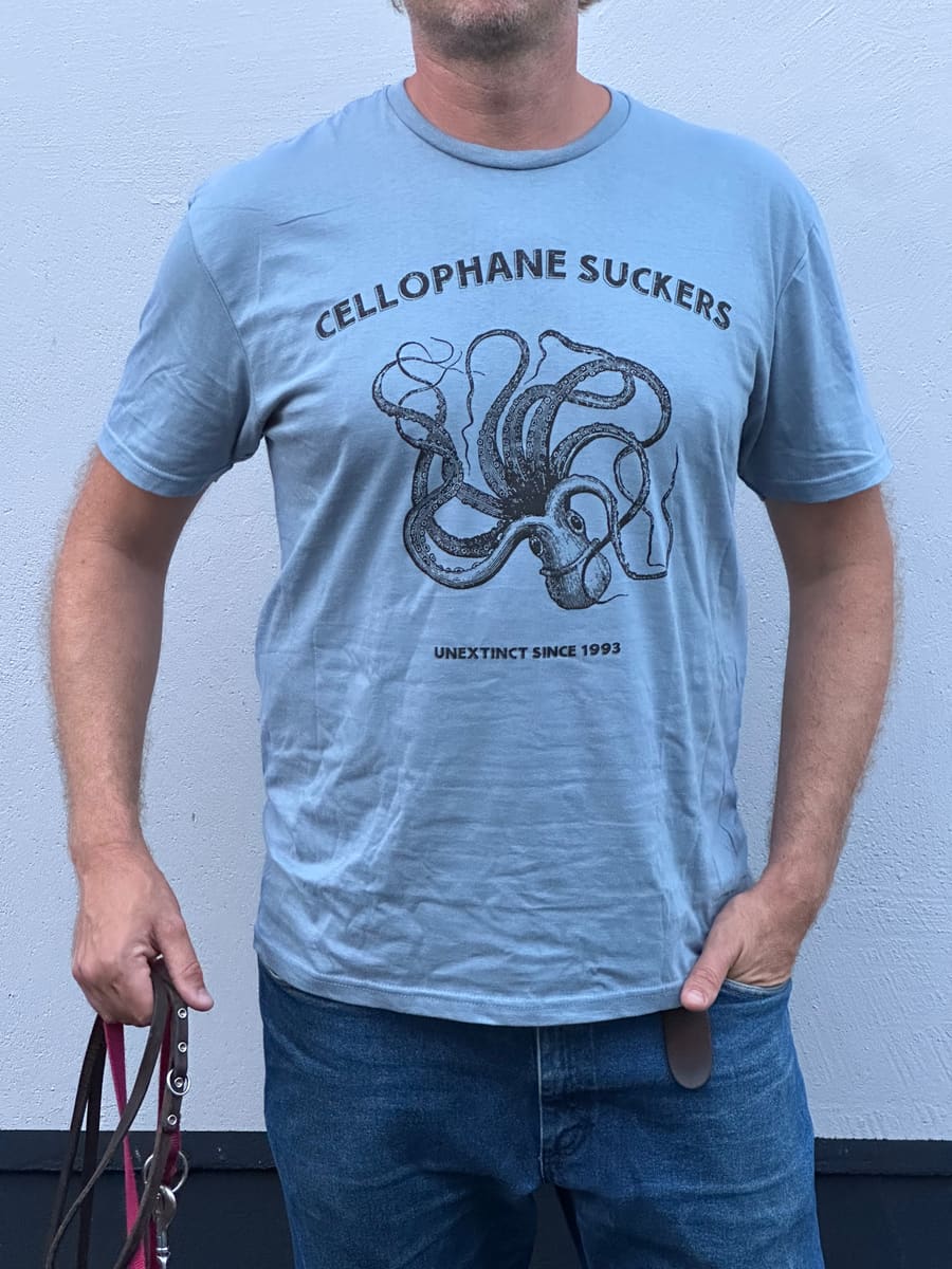 Light blue t-shirt with a black octopus print and the line Unextinct since 1993